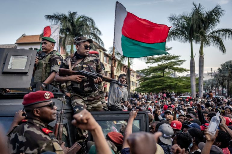 afp_68eb5e05a423-1760255493 Members of a Madagascar army contingent gather with protesters as protesters celebrate as they address them from Antananarivo’s City Hall on October 11, 2025.