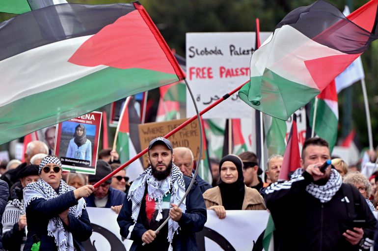 Protesters wave Palestinian's national flags as they take part in a protest in support of the Palestinian people in Sarajevo, on October 12, 2025.