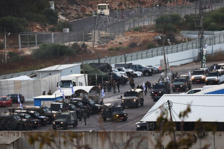 TOPSHOT - Israeli military armoured vehicles take position at the Ofer military prison located between Ramallah and Beitunia in the occupied West Bank on October 13, 2025, ahead of the release of Palestinian prisoners in exchange for hostages held by Hamas in Gaza since the October 7 attacks.