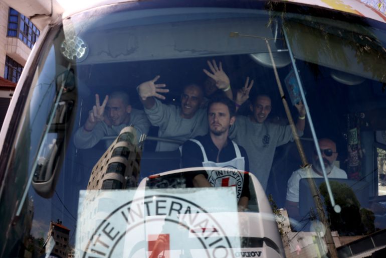 afp_68ece636b43f-1760355894 Palestinian men gesture from inside a bus after being released from the Ofer military prison located between Ramallah and Beitunia in the occupied West Bank on October 13, 2025, in exchange for hostages held by Hamas in Gaza since the October 7 attacks.