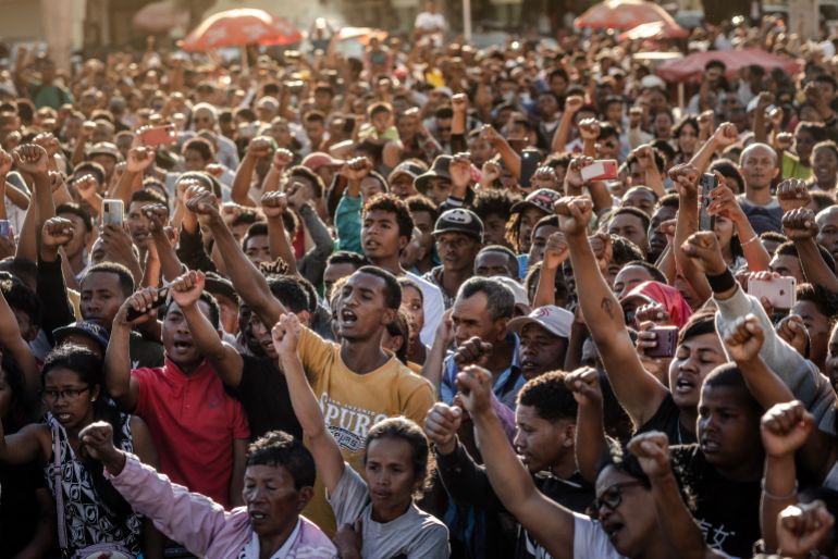 afp_68ed7a7682ee-1760393846 Residents and protesters chant national songs and raise their fists as they gather for a civil society rally demanding the resignation of President Andry Rajoelina and paying tribute to the victims of the protests in Antananarivo, on October 13, 2025.