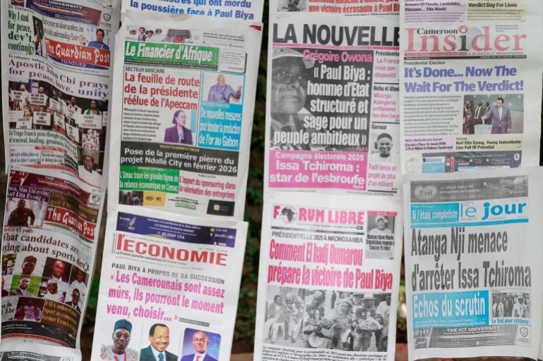 A general view of newspapers on a newsstand the day after the Cameroon presidential election, in Yaounde, on October 13, 2025. (Photo by Daniel BELOUMOU OLOMO / AFP)