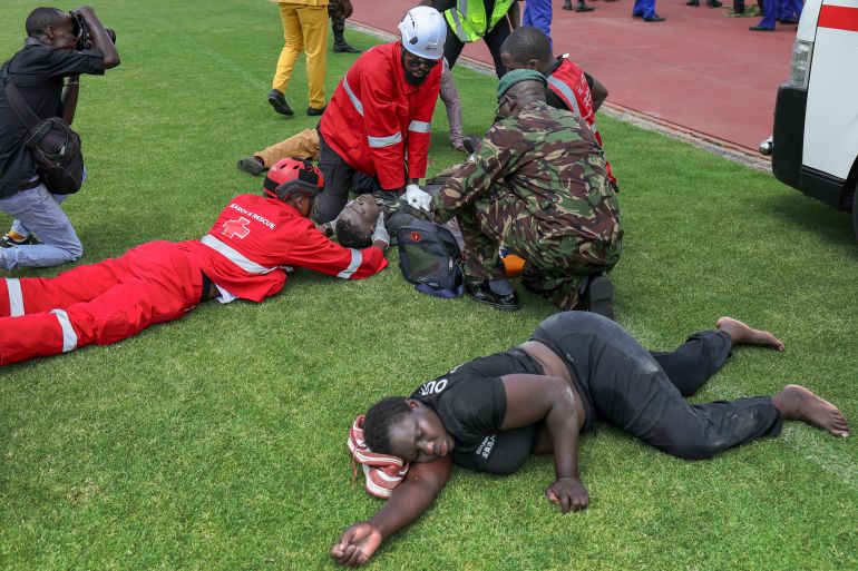 afp_68f26baab834-1760717738 Emergency Medical Service (EMS) personnel attempt to resuscitate a motionless man following a stampede after a crowd of mourners surged from the stands at Nyayo stadium to get a view of the body of Kenya’s opposition leader and former Prime Minister Raila Odinga as it lay in state for public viewing during his State Funeral in Nairobi on October 17, 2025.