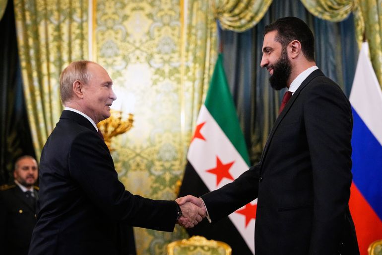 afp_68f474179e51-1760850967 Russian President Vladimir Putin and Syrian interim president Ahmed al-Sharaa shake hands during their meeting at the Grand Kremlin Palace in Moscow on October 15, 2025. (Photo by Alexander Zemlianichenko / POOL / AFP)