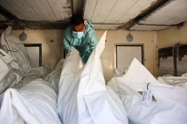 afp_68f49278cdf1-1760858744 A hospital employee checks the remains of Palestinians released by Israel under a Gaza ceasefire and hostage exchange deal, inside a refrigerated truck in front of the Nasser hospital in Khan Yunis in the southern Gaza Strip, on October 18, 2025.