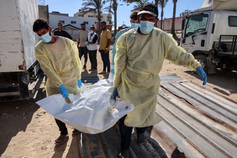 afp_68f492819061-1760858753 Hospital workers transport the remains of a Palestinian released by Israel under a Gaza ceasefire and hostage exchange deal, to the morgue of Nasser hospital in Khan Yunis in the southern Gaza Strip, on October 18, 2025.