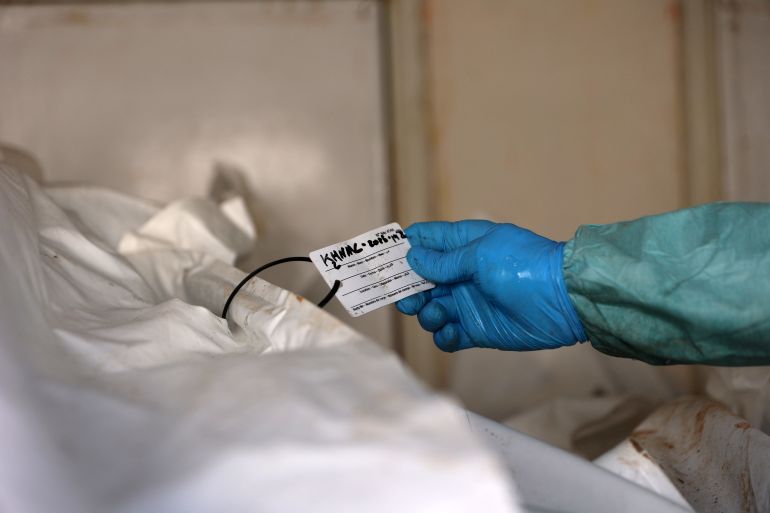 afp_68f4928c6ba5-1760858764 A hospital employee checks the identification card on the remains of a Palestinian released by Israel under a Gaza ceasefire and hostage exchange deal, inside a refrigerated truck in front of the Nasser hospital in Khan Yunis in the southern Gaza Strip, on October 18, 2025.