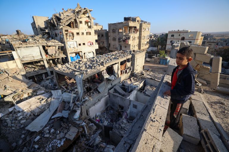 afza-1760970799 A boy looks at the rubbles of buildings destroyed in an Israeli strike in Bureij, central Gaza Strip, on October 20, 2025. US President Donald Trump said October 19 that a ceasefire in Gaza was still holding after Israel carried out deadly strikes on the territory over alleged truce violations by Hamas. (Photo by Eyad BABA / AFP)