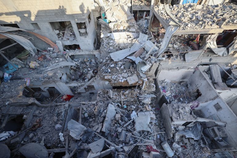 aikes-1760970834 A Palestinian woman inspects the damage in her neighbourhood after an Israeli strike targeted the previous day the Bureij refugee camp in the central Gaza Strip, on October 20, 2025. Israel resumed on October 19 airstrikes on the Palestinian territory, after accusing the Palestinian militant group Hamas of breaking a ceasefire and hostage release deal brokered last week. (Photo by Eyad BABA / AFP)