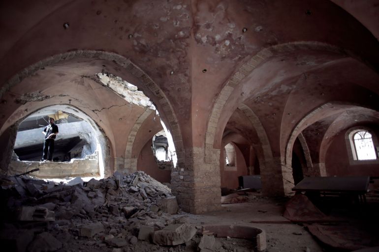 In this Sunday, Aug. 10, 2014 photo, a Palestinian man looks at the damage to the Al-Omary Mosque that was hit by Israeli Strikes in Jabaliya, northern Gaza Strip. Israel has hit and destroyed 63 mosques in Gaza in its month-old war with Hamas, Palestinian officials say. The reason, Israel says, is that Hamas is using mosques to stockpile weapons and rocket launchers and hide tunnels. Gazas Hamas rulers deny the accusations. But in its determination to go after what it says are militant arsenals, Israel is throwing aside any reluctance it had in the past to hit religious sites for fear of a diplomatic backlash. (AP Photo/Khalil Hamra)