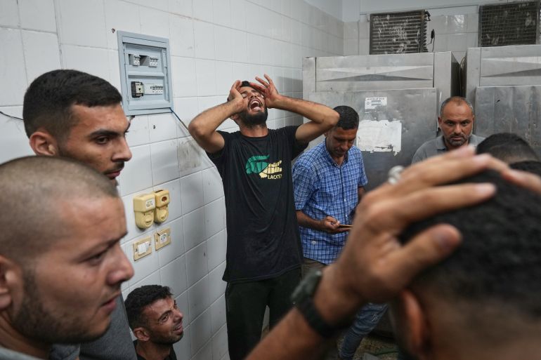 ap_68dcf1a757168-1759310247 Relatives mourn over the family members killed in an Israeli strike on a carpentry shop and a café at the Al-Aqsa hospital in Deir al-Balah in the central Gaza Strip, Tuesday, Sept. 30, 2025.(AP Photo/Abdel Kareem Hana)