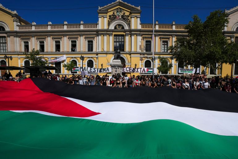 University students demonstrate in support of the Palestinians and against Israel's war in Gaza, in front of the Universidad de Chile building in Santiago, Chile, Tuesday, Oct. 7, 2025. (AP Photo/Esteban Felix)