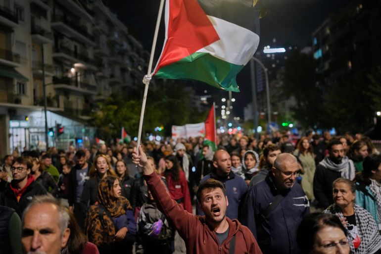 A protester waves a Palestinian flag during a pro-Palestinian demonstration in Athens, Tuesday, Oct. 7, 2025, marking the two-year anniversary of Hamas' attack on Israel. (AP Photo/Petros Giannakouris)
