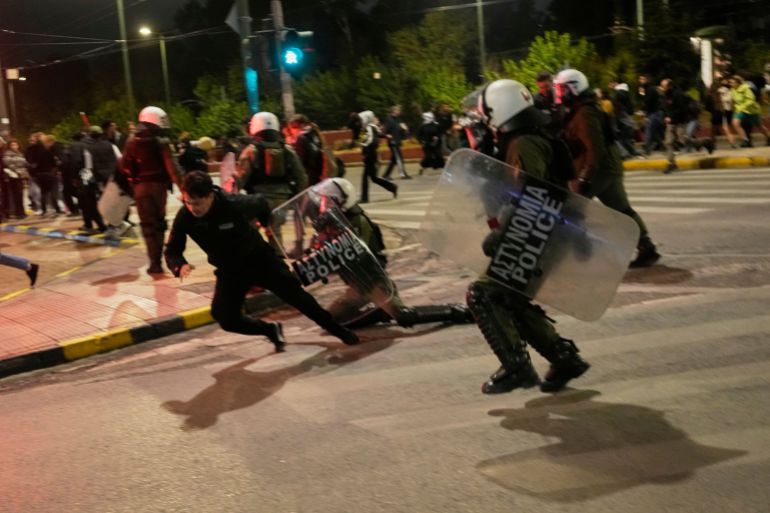 Riot police arrest a protester during a pro-Palestinian demonstration outside the embassy of Israel in Athens, Tuesday, Oct. 7, 2025, marking the two-year anniversary of Hamas' attack on Israel. (AP Photo/Petros Giannakouris)