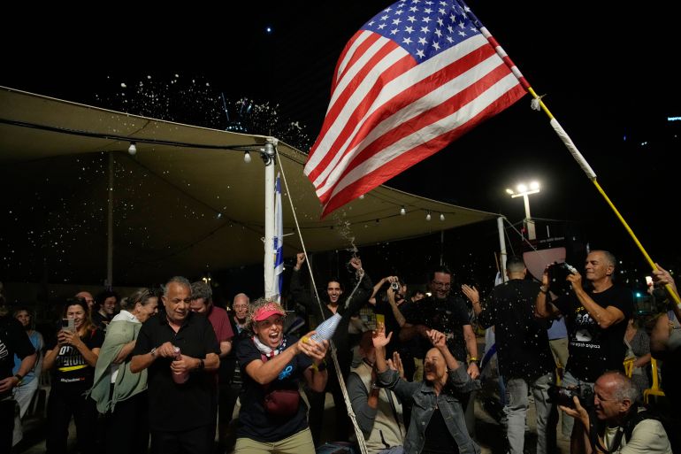 Relatives and supporters of Israeli hostages held by Hamas in the Gaza Strip celebrate after the announcement that Israel and Hamas have agreed to the first phase of a peace plan, as they gather at a plaza known as the hostages square in Tel Aviv, Israel, Thursday, Oct. 9, 2025. (AP Photo/Ohad Zwigenberg)