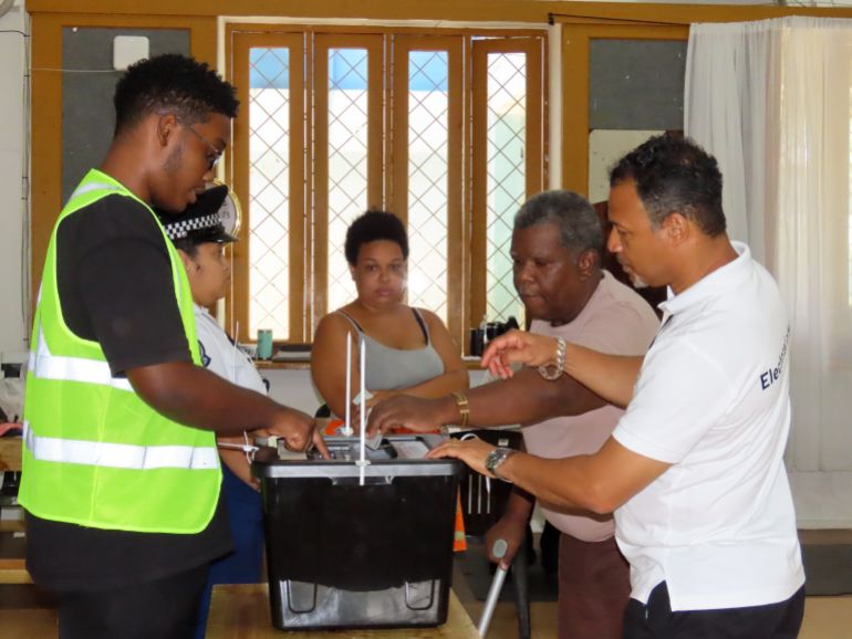 ap_68eb34a38218f-1760244899 A woman casts her vote in a runoff presidential election at Mont Fleuri Secondary School, Mont Fleuri, Mahe, Seychelles, Saturday, Oct. 11, 2025. (AP Photo/Emilie Chetty)