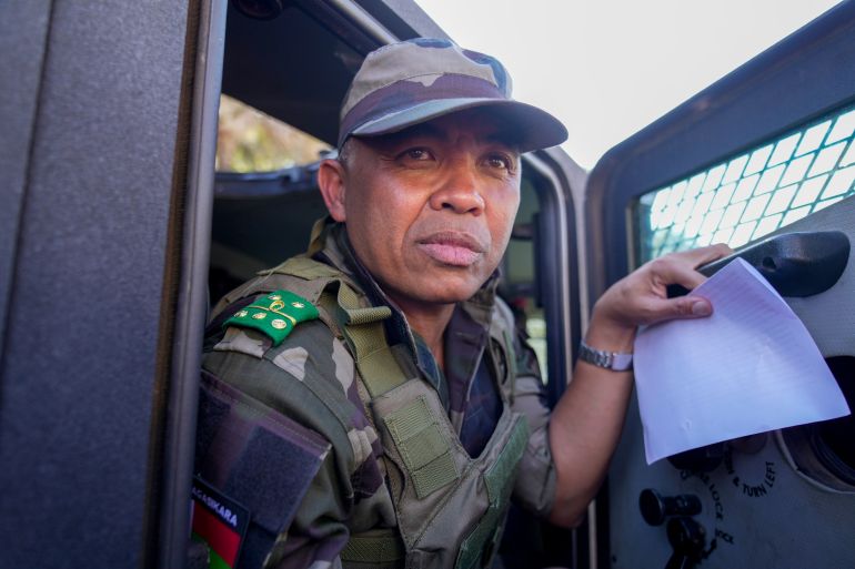 ap_68ef650d3fd38-1760519437 CAPSAT military unit commander Col. Michael Randrianirina and his troops make their way to the presidency to announce that the armed forces are taking control of the country in Antananarivo, Madagascar, Tuesday, Oct. 14, 2025. (AP Photo/Brian Inganga)