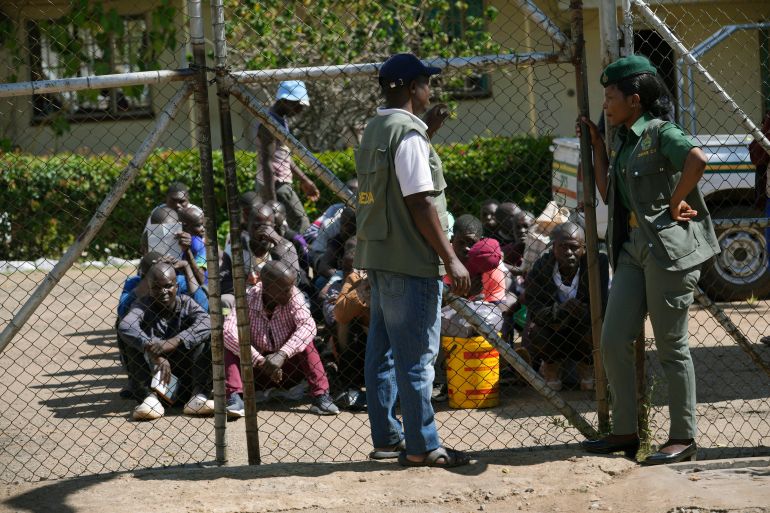 ap_68f470438362f-1760849987 Prison officials stand outside of the entrance of Chikurubi Maximum prison while waiting for prisoners to be released, on the outskirts of the capital Harare, Thursday, April 18, 2024. Zimbabwe President Emmerson Mnangagwa has granted amnesty to more than 4,000 prisoners in an independence day amnesty. The amnesty coincided with the country's 44th anniversary of independence from white minority rule on Thursday and included some prisoners who were on death row. (AP Photo/Tsvangirayi Mukwazhi)
