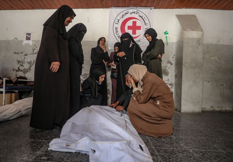 epa_68f396589717-1760794200-1 epa12462103 Palestinian relatives of the Abu Shaban family mourn around the bodies of their loved ones at Al Ahli Baptist Hospital in Gaza City, 18 October 2025. At least eleven members of the Abu Shaban family were killed a day earlier when their car was hit by an Israeli army strike in the Al Zaitun neighbourhood, east of Gaza City. EPA/MOHAMMED SABER