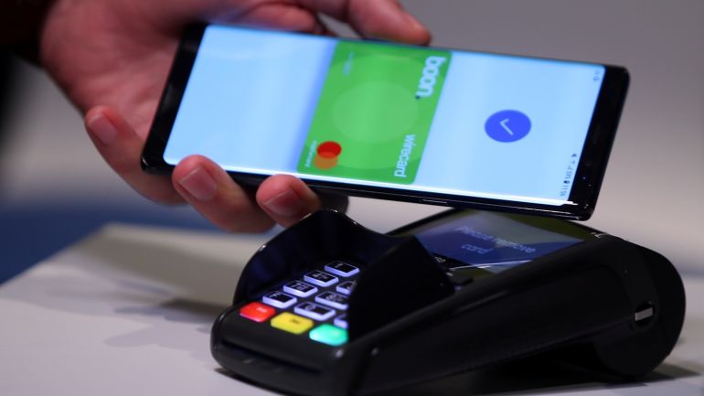 An employee of Wirecard AG, an independent provider of outsourcing and white label solutions for electronic payment transactions, presents the contactless payment system