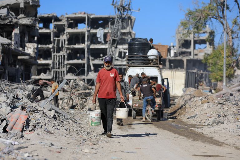 gaza1-0-1760697013 Palestinians pass by the rubble of destroyed buildings, amid a ceasefire between Israel and Hamas, in Gaza City, October 14, 2025. REUTERS/Dawoud Abu Alkas