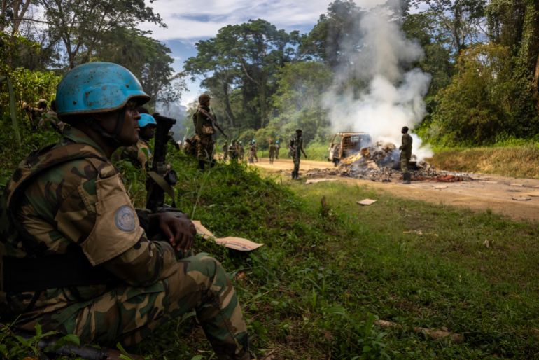 KILYA, RWENZORI SECTOR, DEMOCRATIC REPUBLIC OF THE CONGO - APRIL 09: Congolese Army Soldiers and UN troops inspect an ambush site where an hour previously ADF fundamentalist rebels attacked two vehicles on the road between Beni and the Ugandan border town of Kasindi, on April 9, 2021 in Kilya, Rwenzori Sector, Democratic Republic of the Congo. ADF killed three civilians in the vehicles, assassinating them with shots to the head outside of their vehicles, there was also evidence of cuts from machetes. The Malawian contingent of the UN’s MONUSCO force arrived on scene as the ambush was ending and the vehicles were being set on fire. They engaged a large force of ADF fighters, killing one of them. That fighter was stripped of his uniform by other ADF fighters during the firefight, they then fled into the jungle. The purpose of the ADF’s attacks is to spread terror amongst the civilian population. There have been multiple attacks across the province by ADF, all characterized by brutality and on occasion, beheadings. The ADF is an Islamic terror group based out of Eastern DR Congo that, in recent years, has developed a relationship with the Islamic State after pledging allegiance to ISIS leadership. They are known locally as ISIS in Congo. (Photo by Brent Stirton/Getty Images)