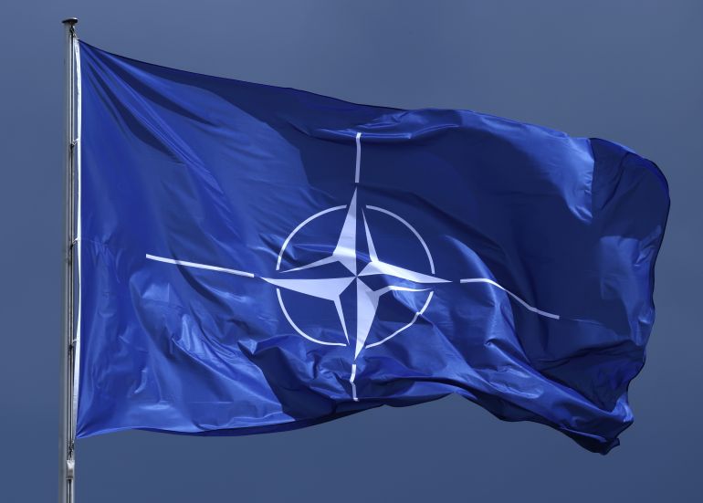 getty_68ed28faf3-1760372987 BERLIN, GERMANY - JULY 09: The NATO flag flies prior to a meeting between German Chancellor Friedrich Merz and NATO Secretary General Mark Rutte at the Chancellery on July 09, 2025 in Berlin, Germany. Rutte recently warned of imperialist ambitions by both Russia and China that could spark a third world war. (Photo by Sean Gallup/Getty Images)