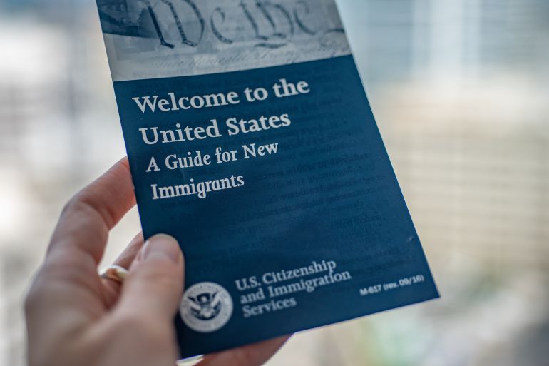 Washington, DC, USA - September, 9, 2020: Welcome to the United States"nA Guide for New Immigrants Brochure in female hand on blurred background. Settling in the U.S. concept.