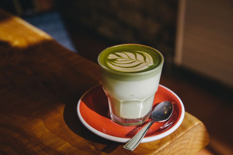 gettyimages-2148302545-1744561786 Matcha latte in a glass