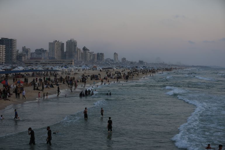 GAZA CITY, GAZA - JUNE 13: Fishermen facing starvation continue to fish around the port to feed their families, while some civilians spend their time on the beach, trying to survive under the harsh conditions amid Israeli attacks in Gaza City, Gaza on June 13, 2025. Palestinians deprived of basic necessities such as shelter, food, and clean water in the Gaza Strip are struggling to survive in tent camps along the coast. (Photo by Dawoud Abo Alkas/Anadolu via Getty Images)