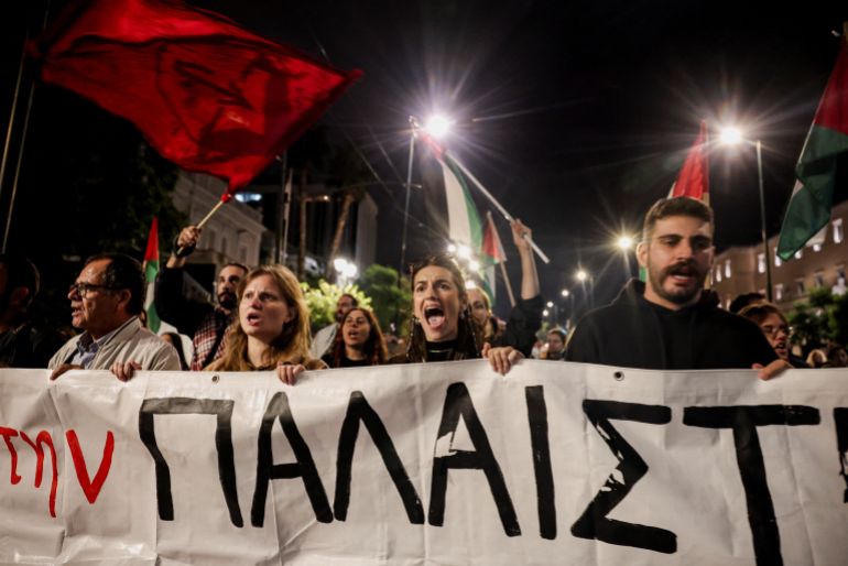 Pro-Palestinian activists hold a banner as they protest to condemn the interception of the vessels of the Global Sumud Flotilla, outside the Ministry Of Foreign Affairs in Athens, Greece, October 2, 2025. REUTERS/Louisa Gouliamaki