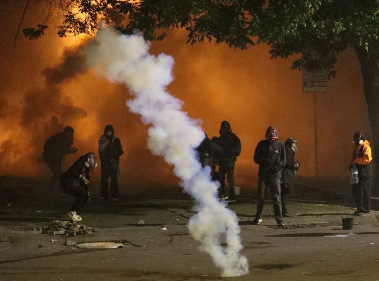 Protesters react to tear gas during an opposition rally on the day of local elections in Tbilisi, Georgia October 4, 2025. REUTERS/Irakli Gedenidze