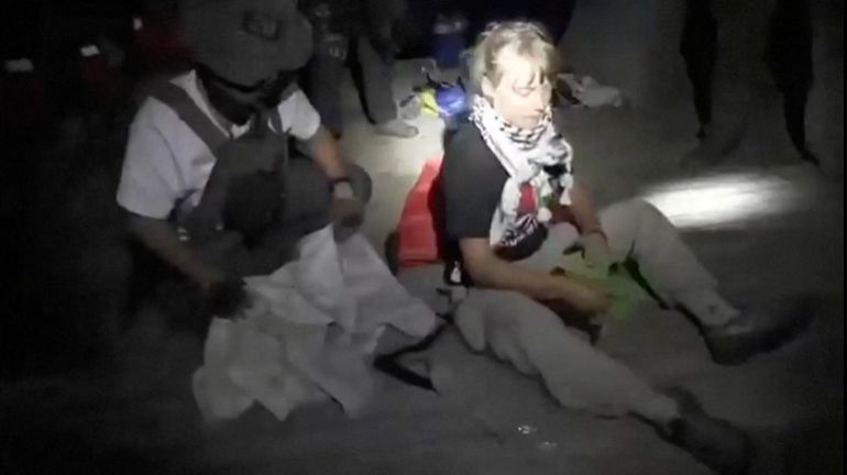A screengrab from a video shows Swedish activist Greta Thunberg sitting next to a person wearing tactical gear, as vessels of the Global Sumud Flotilla are being intercepted by Israeli security forces, October 1, 2025. Israel Foreign Ministry/Handout via REUTERS THIS IMAGE HAS BEEN SUPPLIED BY A THIRD PARTY. MANDATORY CREDIT. NO RESALES. NO ARCHIVES.