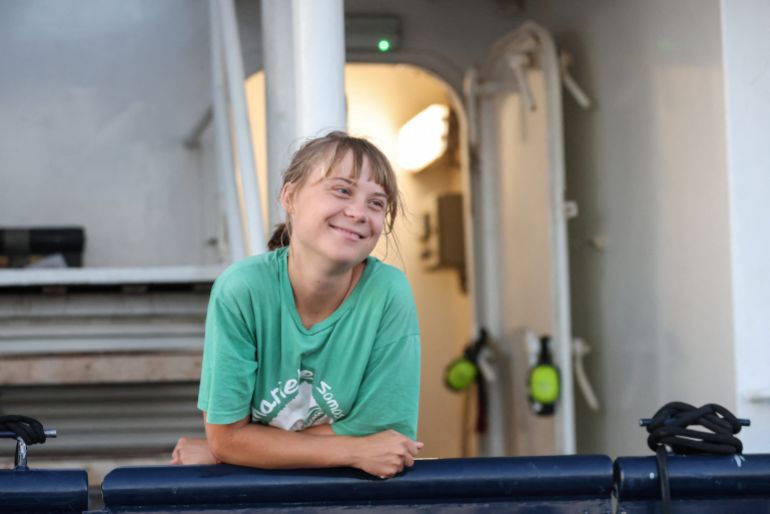 Greta Thunberg smiles aboard a ship, part of the Global Sumud Flotilla aiming to reach Gaza and break Israel's naval blockade, as they sail off Crete island, Greece, September 25, 2025. REUTERS/Stefanos Rapanis