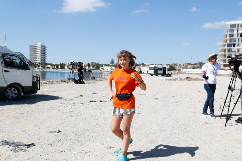 Swedish activist Greta Thunberg, a member of the Global Sumud Flotilla, walks as she waits to set sail towards Gaza, with other boats from Tunisia, as part of an international humanitarian aid initiative to break Israel's naval blockade and deliver vital supplies to Palestinians, at the port of Bizerte, Tunisia September 13, 2025. REUTERS/Zoubeir Souissi