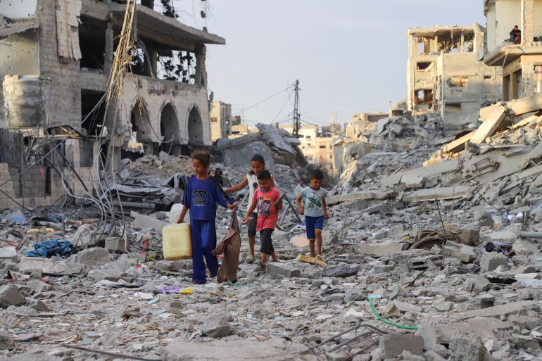 Palestinian children walk near rubble in the aftermath of an Israeli offensive carried out before a ceasefire between Israel and Hamas was reached, at Shati (Beach) refugee camp in Gaza City, October 12, 2025. REUTERS/Ebrahim Hajjaj