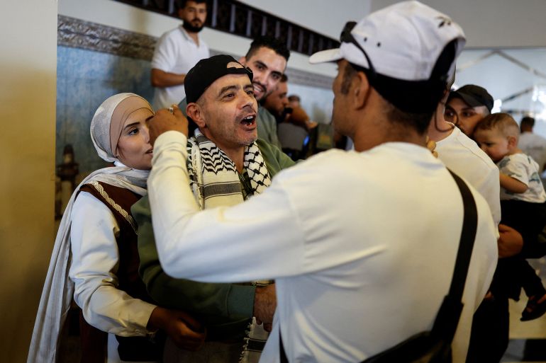 reuters_68ecea1f-1760356895 A freed Palestinian is greeted by his relatives and friends after he was released from an Israeli jail as part of a hostages-prisoners swap and a ceasefire deal in Gaza between Hamas and Israel, in Ramallah, in the Israeli-occupied West Bank, October 13, 2025. REUTERS/Ammar Awad