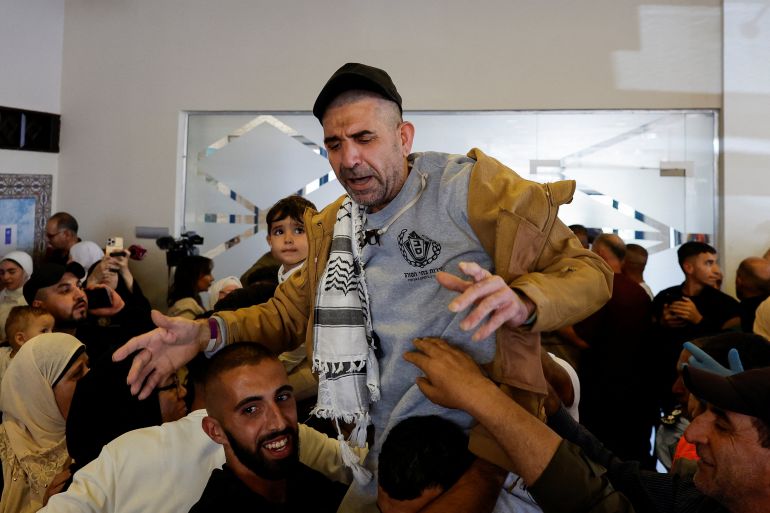 reuters_68ecea26-1760356902 A freed Palestinian prisoner is carried as he is greeted by his relatives and friends after he was released from an Israeli jail as part of a hostages-prisoners swap and a ceasefire deal in Gaza between Hamas and Israel, in Ramallah, in the Israeli-occupied West Bank, October 13, 2025. REUTERS/Ammar Awad