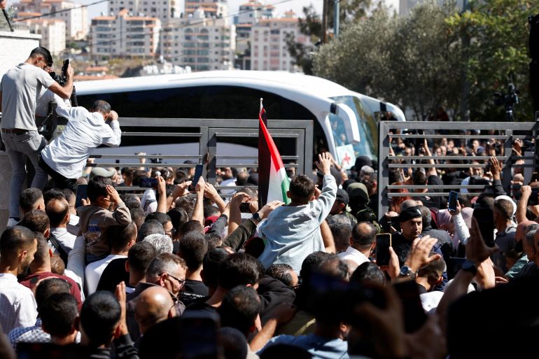 reuters_68ecea42-1760356930 People gather to greet freed Palestinian prisoners as they arrive after being released from an Israeli jail as part of a hostages-prisoners swap and a ceasefire deal in Gaza between Hamas and Israel, in Ramallah, in the Israeli-occupied West Bank, October 13, 2025. REUTERS/Mohammed Torokman
