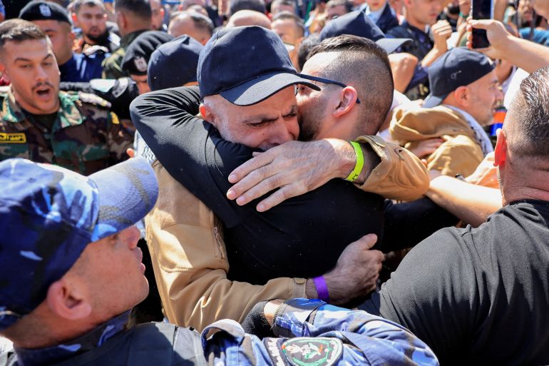 reuters_68ecea87-1760356999 A freed Palestinian prisoner hugs his family member after being released from an Israeli jail as part of a hostages-prisoners swap and a ceasefire deal in Gaza between Hamas and Israel, in Ramallah, in the Israeli-occupied West Bank, October 13, 2025. REUTERS/Mussa Qawasma TPX IMAGES OF THE DAY
