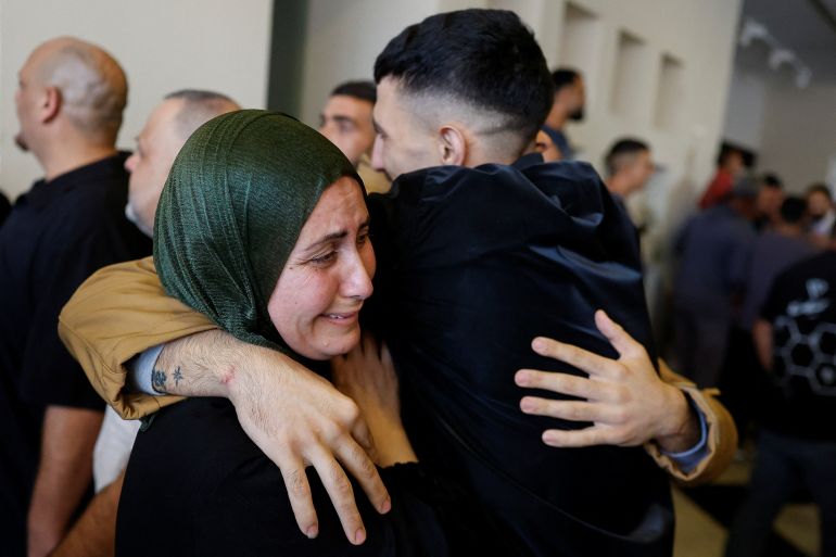 reuters_68eceaa9-1760357033 Relatives hug a freed Palestinian prisoner after he was released from an Israeli jail as part of a hostages-prisoners swap and a ceasefire deal in Gaza between Hamas and Israel, in Ramallah, in the Israeli-occupied West Bank, October 13, 2025. REUTERS/Ammar Awad