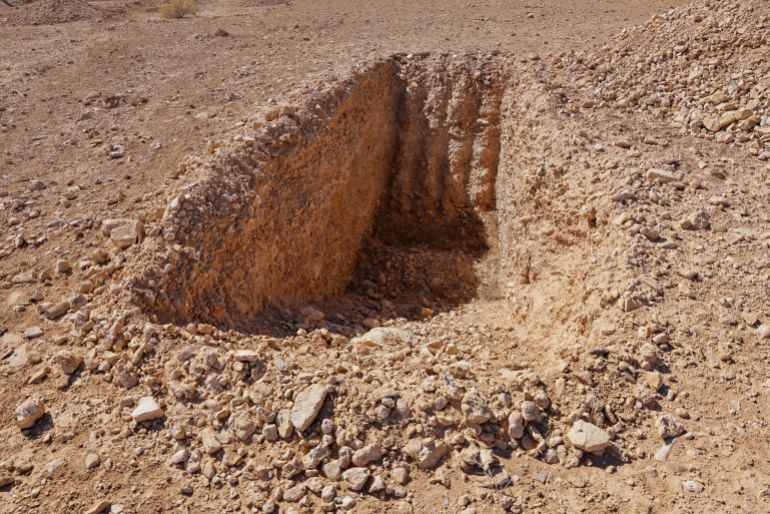 A detail of what one witness told Reuters was an incomplete trench dug to take bodies in this mass grave site in the desert near the eastern Syrian town of Dhumair, February 27, 2025. A Reuters investigation found that the Assad government secretly trucked thousands of bodies there from an exposed mass grave in the Damascus suburb of Qutayfah from 2019-2021. REUTERS/Khalil Ashawi