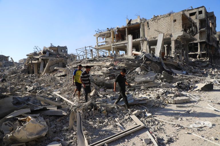 reuters_68ef810e-1760526606 Palestinians inspect the damage in a neighborhood in the aftermath of an Israeli operation, after Israel's government ratified a ceasefire with Hamas, in Gaza City October 10, 2025. REUTERS/ Ebrahim Hajjaj
