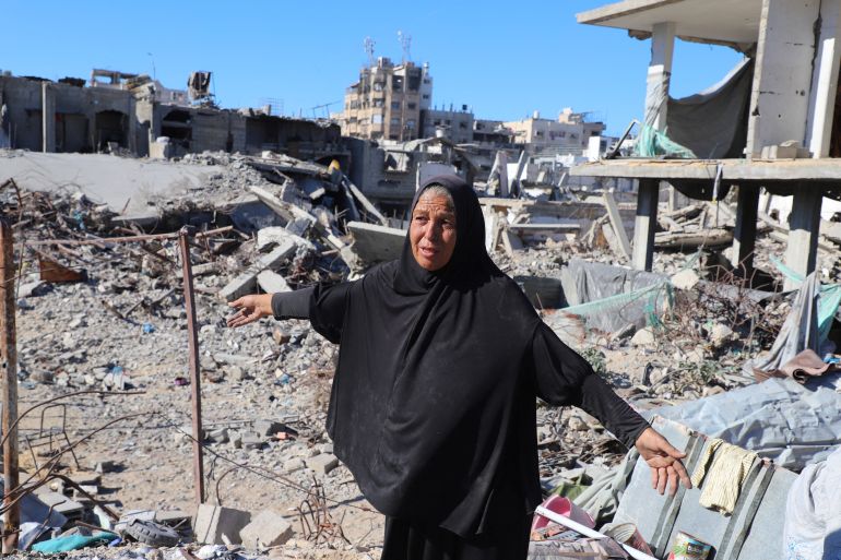 reuters_68f4941d-1760859165 A Palestinian woman, Hayam Meqdad, 49, walks on the rubble of her destroyed home, as she now lives in a tent after getting displaced during the war, after a ceasefire between Israel and Hamas in Gaza went into effect, in Gaza City, October 15, 2025. REUTERS/Ebrahim Hajjaj