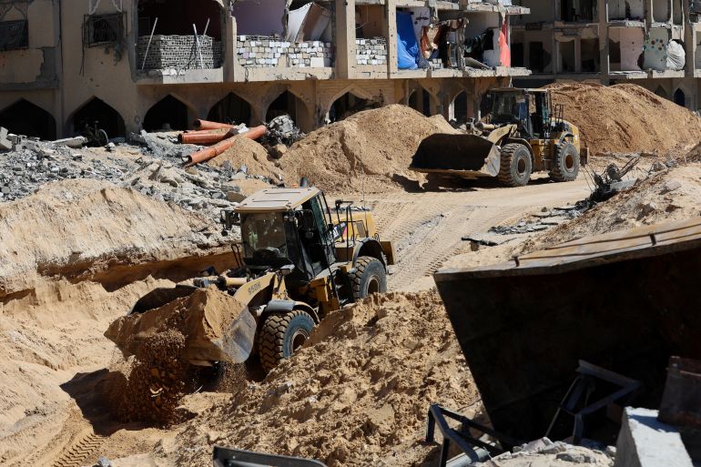 reuters_68f4a3d4-1760863188 Heavy machinery operates at a site where searches are underway for the bodies of hostages killed after being seized by Hamas during the October 7, 2023 attack, amid a ceasefire between Israel and Hamas, in Khan Younis, southern Gaza Strip, October 18, 2025. REUTERS/Ramadan Abed