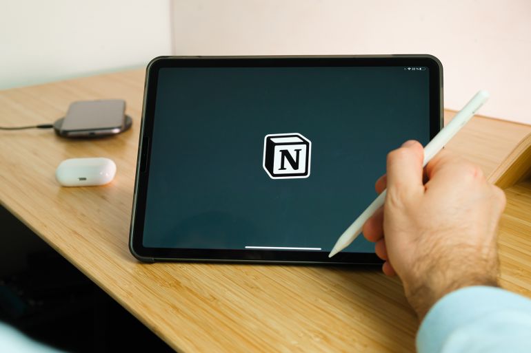 Notion is used with apple pencil on iPad Pro tablet . Man using application on the tablet. December 2020, San Francisco, USA.; Shutterstock ID 1876791724; purchase_order: aj; job: ; client: ; other: