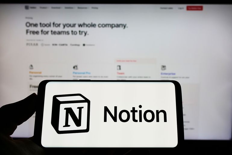 Stuttgart, Germany - 07-30-2022: Person holding mobile phone with logo of American software company Notion Labs Inc. on screen in front of web page. Focus on phone display. Unmodified photo.; Shutterstock ID 2185809131; purchase_order: aj; job: ; client: ; other:
