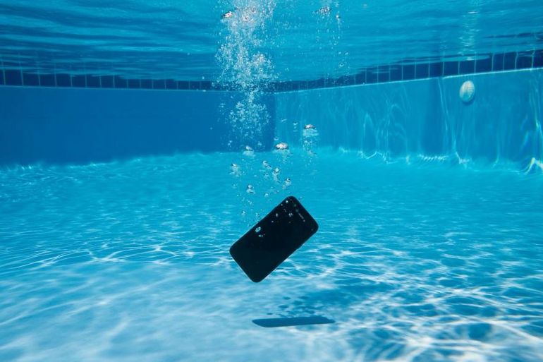 phone dropped in pool underwater; Shutterstock ID 2498668213; purchase_order: AJA; job: ; client: ; other: ; is_generated: true