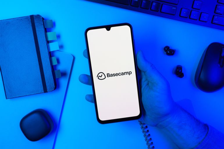 Prague, Czechia - 10 21 2024: Smartphone on surface showing Basecamp logo.; Shutterstock ID 2585323087; purchase_order: aj; job: ; client: ; other: