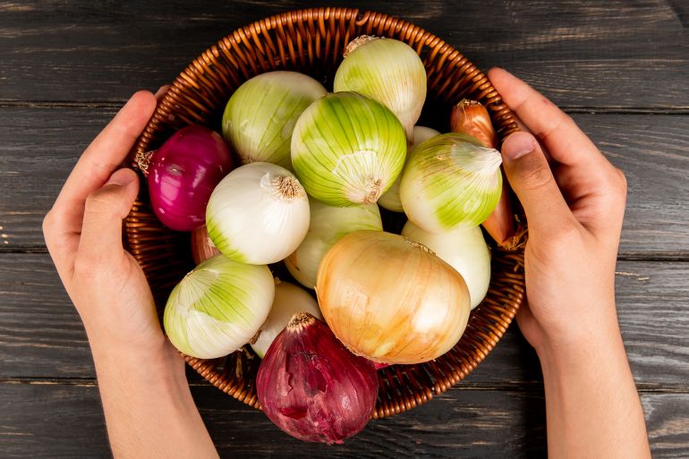 Top view of onions as red white shallot and sweet ones in basket فري بيك